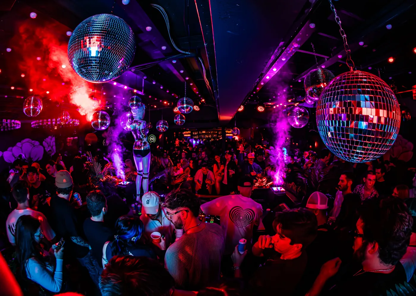 Mirror balls over a packed room