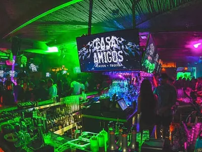 Casa Amigos bar under green and magenta light