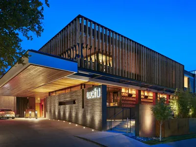 Uchi exterior at blue hour, slatted timber facade